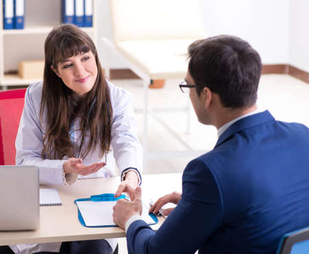 Man signing medical insurance contractの写真素材