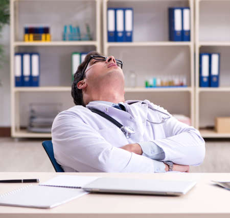 Young doctor sitting in the officeの写真素材