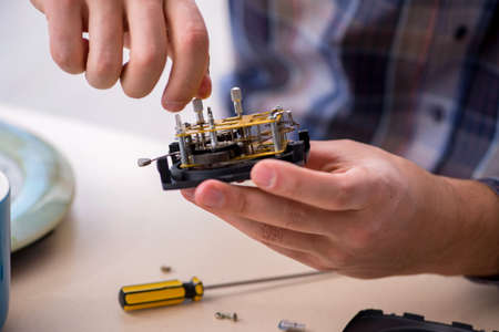 Young male watchmaker working in the workshopの写真素材