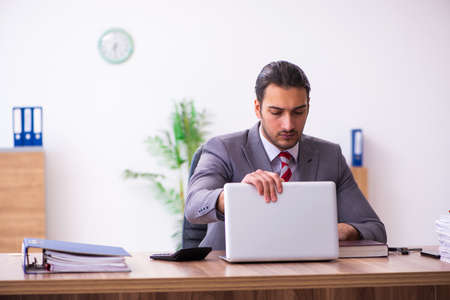 Young male employee working in the officeの写真素材