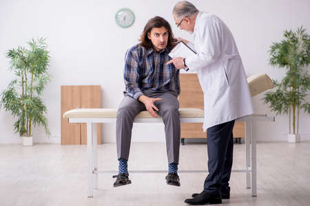 Young male patient visiting experienced doctor psychiatristの写真素材