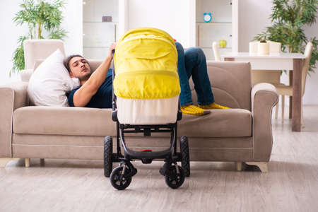 Young father looking after newbornの写真素材