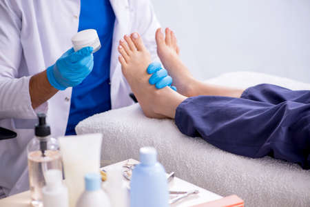 Podiatrist treating feet during procedureの写真素材