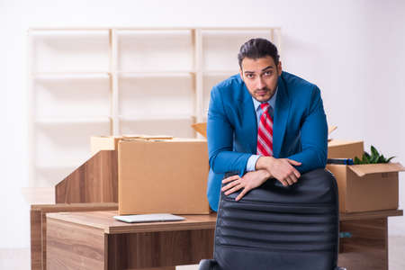 Young male employee in relocation conceptの写真素材