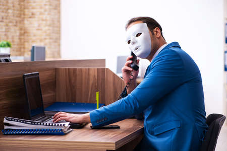 Young male employee wearing mask in the officeの写真素材