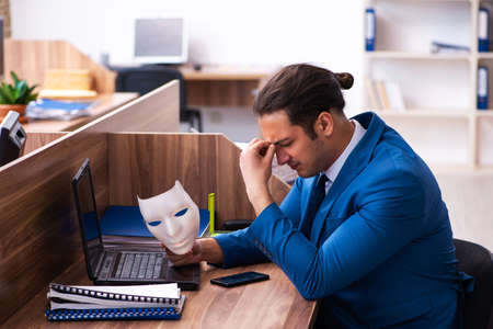 Young male employee wearing mask in the officeの写真素材