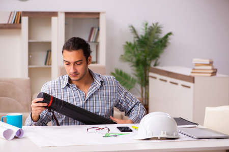 Young male architect working from house during pandemicの写真素材