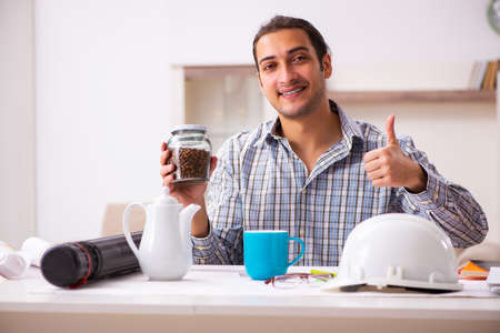 Young male architect working from house during pandemicの写真素材