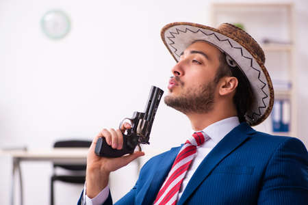 Young businessman cowboy working in the office