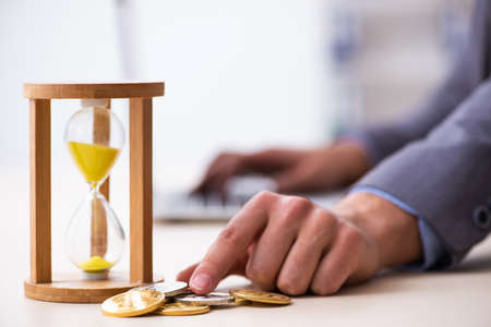 Young man earning money via Internet in time management concept