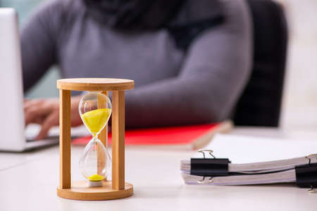 Young male writer in time management conceptの写真素材