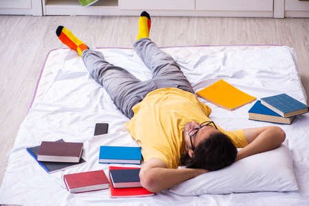 Young male student preparing for exams at home