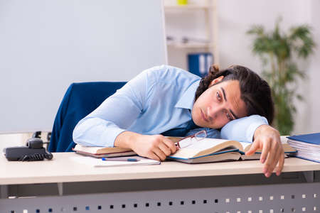 Young businessman student studying at workplaceの写真素材