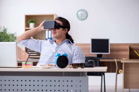 Young male businessman employee working in the office