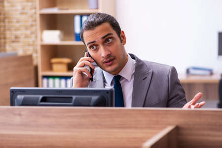 Young male employee working in the officeの写真素材