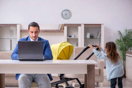 Young divorced father of two children working from houseの写真素材