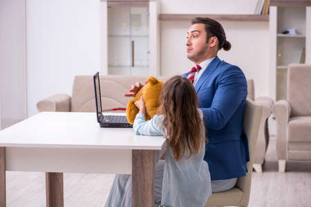 Girl bothering young father during working from house in pandemiの写真素材