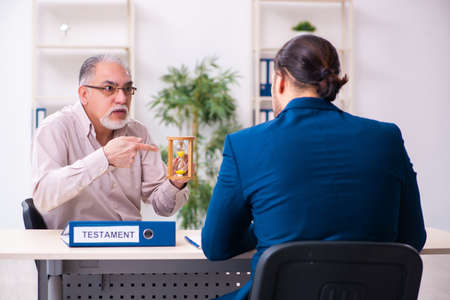 Young male lawyer and old man in testament and time management c