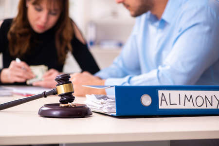 Young couple divorcing in alimony conceptの写真素材