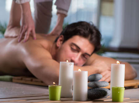 Young handsome man during spa procedureの写真素材