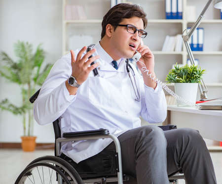 Disabled doctor on wheelchair working in hospitalの写真素材