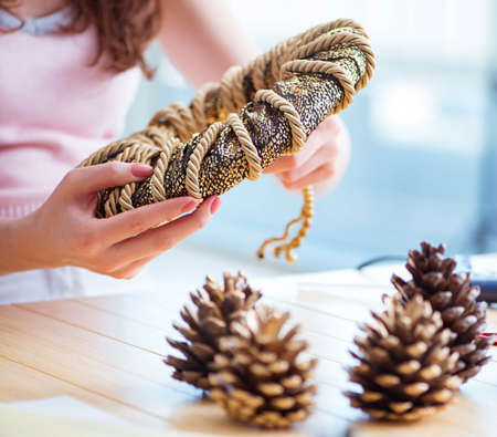 Woman making homemade cone wreathの写真素材