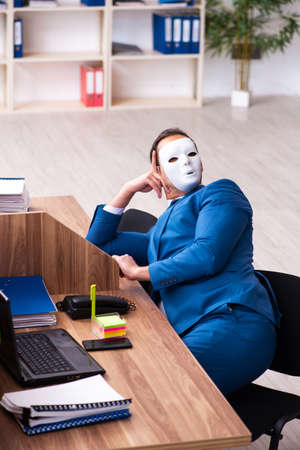 Young male employee wearing mask in the officeの写真素材