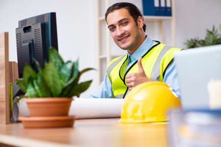 Young male architect working in the office