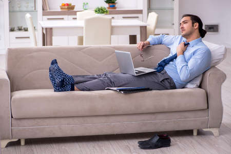 Tired businessman employee working from homeの写真素材