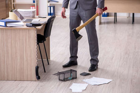 Young male employee and mousetrap in the officeの写真素材