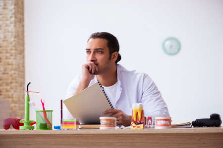 Young male dentist working in the clinicの写真素材