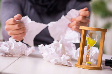 Young male writer in time management concept