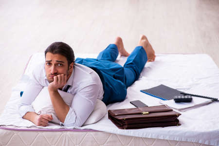 Young male employee working from home during pandemicの写真素材