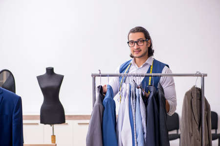 Young male tailor working at workshopの写真素材