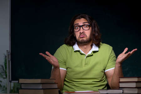 Young male student preparing for exams in the classroomの写真素材