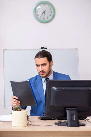 Young male businessman employee working in the officeの写真素材
