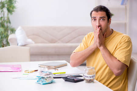 Young man in budget planning conceptの写真素材