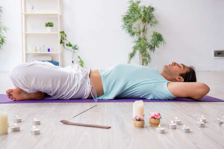 Young man during yoga session at home