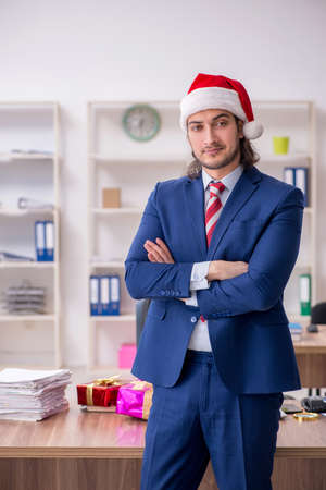 Young male employee working in the office at Christmas Eveの写真素材
