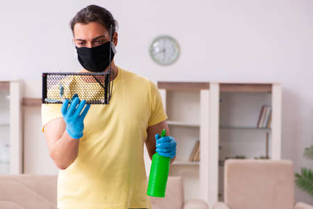 Young man and mousetrap at homeの写真素材