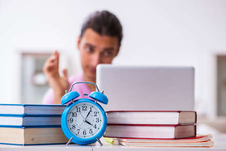Male student in love preparing for exams in time management concの写真素材