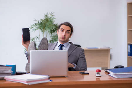 Young male employee wearing virtual glasses in the officeの写真素材