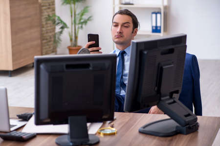 Young male employee working in the officeの写真素材