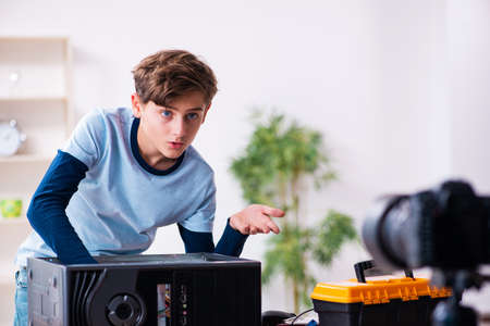 Boy computer repairman recording video for his blogの写真素材