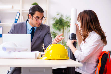 Young businessman and female architect discussing new projectの写真素材