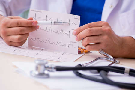 Young male doctor cardiologist working in the clinicの写真素材