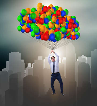 Businessman flying on balloons in challenge concept