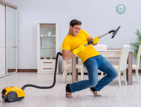 Young man doing chores at homeの写真素材
