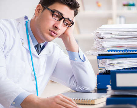 Busy doctor with too much work in hospitalの写真素材