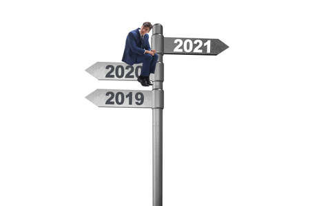 Road sign and businessman with 2020 and 2021